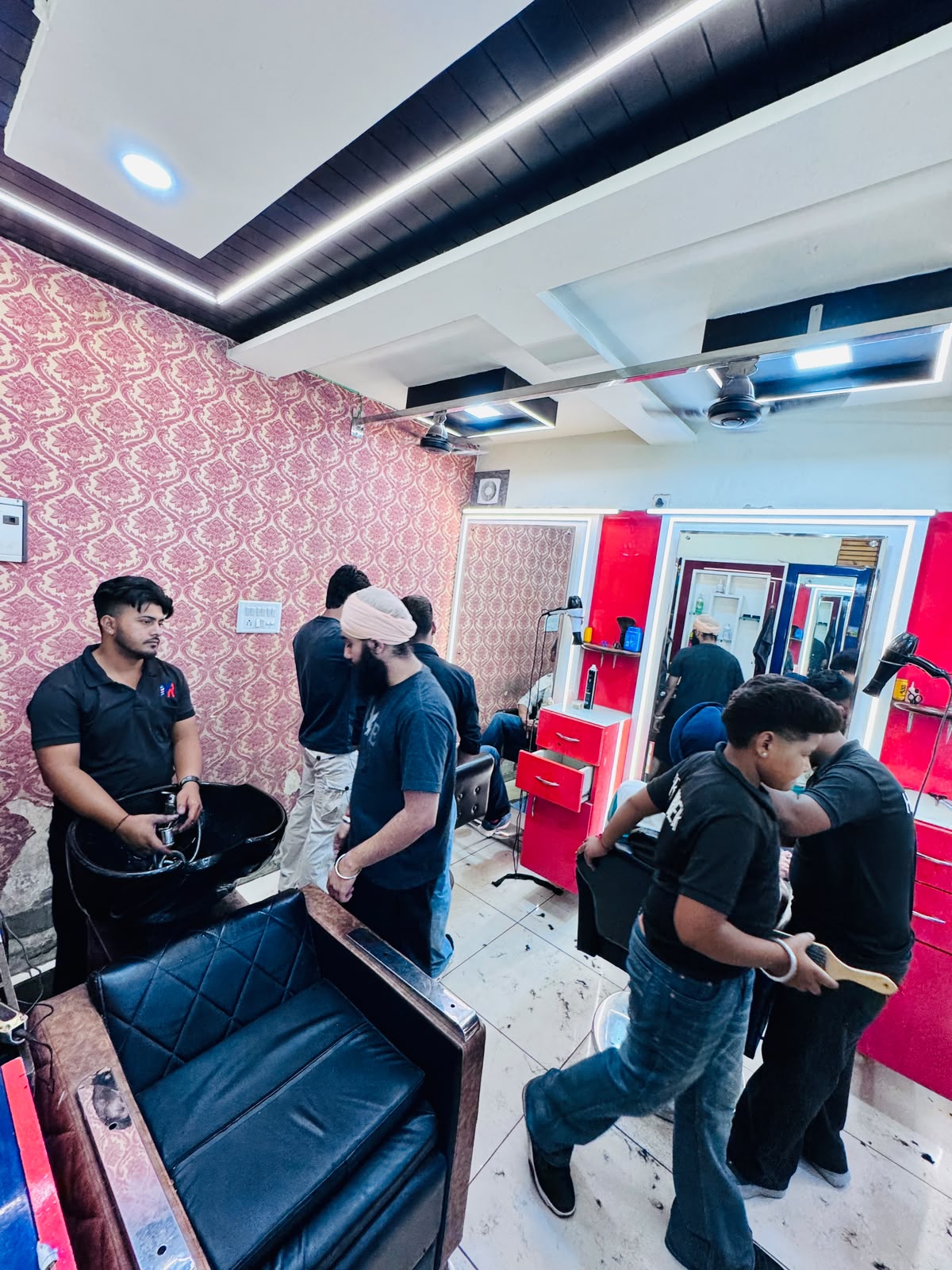 Barbers and customers on the busy MR HERO BARBER service floor