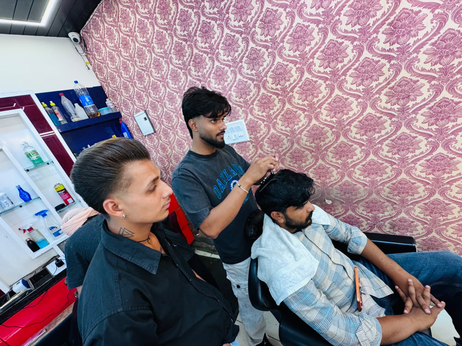 Barber working carefully on a customer's haircut at MR HERO BARBER