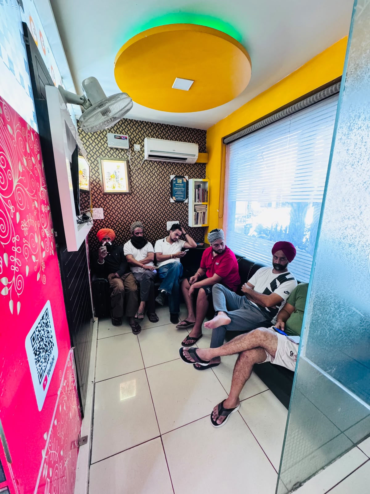 Customers seated in the MR HERO BARBER waiting area in Sunam